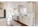 A bright kitchen with white cabinetry, stainless steel appliances, and hardwood floors at 3501 W 41St Ave, Denver, CO 80211