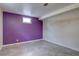Basement area with a vibrant purple wall and tile flooring, offering a unique living space at 10900 Mildred Dr, Northglenn, CO 80233