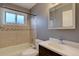 Cozy bathroom with a tub and shower, mirrored cabinet, and a modern sink at 10900 Mildred Dr, Northglenn, CO 80233