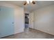 Bedroom with tile floors, ceiling fan, and open doorway at 10900 Mildred Dr, Northglenn, CO 80233