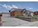 Charming single-story brick home featuring an inviting front yard and a detached two-car garage at 10900 Mildred Dr, Northglenn, CO 80233