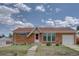 Classic brick home with a well-maintained lawn and inviting front entrance, perfect for curb appeal at 10900 Mildred Dr, Northglenn, CO 80233