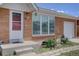 Close-up of a charming brick home with well-maintained landscaping and an attached single-car garage at 10900 Mildred Dr, Northglenn, CO 80233