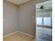 Neutral hallway featuring tile flooring that leads to a bright room with a ceiling fan at 10900 Mildred Dr, Northglenn, CO 80233