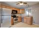 Functional kitchen with stainless steel appliances, light wood cabinets, and tile flooring for easy maintenance at 10900 Mildred Dr, Northglenn, CO 80233