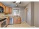 Efficient kitchen layout featuring stainless steel appliances, wood cabinets, and a convenient sink near the window at 10900 Mildred Dr, Northglenn, CO 80233