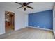 Inviting living room featuring hardwood floors, a ceiling fan, and an open doorway to the kitchen at 10900 Mildred Dr, Northglenn, CO 80233