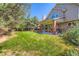 Lush backyard with a covered patio offers a serene outdoor retreat at 9096 E Colorado Cir, Denver, CO 80231
