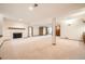 Spacious finished basement featuring a fireplace, neutral carpet, and access to additional rooms at 9096 E Colorado Cir, Denver, CO 80231