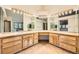 Large bathroom features a spacious vanity with double sinks, granite counters, and ample storage at 9096 E Colorado Cir, Denver, CO 80231