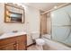 Tiled bathroom featuring a shower and tub combo, vanity with sink, and modern fixtures at 9096 E Colorado Cir, Denver, CO 80231