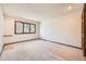 Spacious bedroom features neutral carpet, base trim, and a window with natural light at 9096 E Colorado Cir, Denver, CO 80231
