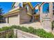 Gorgeous home exterior with brick accents, a three-car garage, and a stone walkway to the front door at 9096 E Colorado Cir, Denver, CO 80231