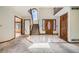 Inviting foyer with marble flooring, a grand staircase, and a decorative stained-glass front door at 9096 E Colorado Cir, Denver, CO 80231