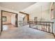 Upstairs landing featuring wood railings, high ceilings, wood flooring, and carpet at 9096 E Colorado Cir, Denver, CO 80231