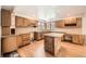 Well-lit kitchen with wood cabinets, granite counters, tile backsplash, and stainless steel appliances at 9096 E Colorado Cir, Denver, CO 80231