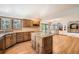 Large kitchen with center island, wooden cabinets, countertops, and an open floor plan at 9096 E Colorado Cir, Denver, CO 80231