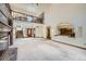 Open-concept living room with a fireplace, staircase, and entrance to the dining and kitchen areas at 9096 E Colorado Cir, Denver, CO 80231
