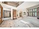 Bright and airy living room featuring a soaring ceiling, large windows, and a marble-tiled entryway at 9096 E Colorado Cir, Denver, CO 80231