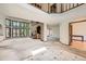 Spacious living room boasting a brick fireplace, large windows, and an open floor plan with carpet at 9096 E Colorado Cir, Denver, CO 80231