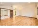 Open living area with hardwood floors and access to other rooms and bathroom at 9096 E Colorado Cir, Denver, CO 80231