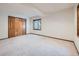 Neutral room with carpet, natural trim, baseboard, window and a closet, ready to be customized at 9096 E Colorado Cir, Denver, CO 80231