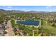 Aerial view of houses in a suburban neighborhood with a small lake nearby at 10832 W Powers Pl, Littleton, CO 80127