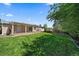 Large grassy backyard with a covered back patio connected to the house at 10832 W Powers Pl, Littleton, CO 80127