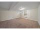 Unfinished basement with carpet, built-in shelves, and neutral walls at 10832 W Powers Pl, Littleton, CO 80127