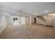 Large unfinished basement with sliding glass door and staircase at 10832 W Powers Pl, Littleton, CO 80127