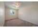 Spacious bedroom with soft carpet, clean trim, and a bright window at 10832 W Powers Pl, Littleton, CO 80127