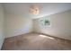 Empty bedroom with neutral tones, plush carpet, and a large window at 10832 W Powers Pl, Littleton, CO 80127