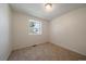 Bedroom featuring neutral carpet, natural light, and clean white walls at 10832 W Powers Pl, Littleton, CO 80127