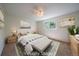 Comfortable bedroom with neutral tones, plush carpet, and a large window, virtually staged at 10832 W Powers Pl, Littleton, CO 80127