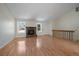 Spacious living room offering hardwood floors, a fireplace, and abundant light from multiple windows, perfect for gatherings at 10832 W Powers Pl, Littleton, CO 80127