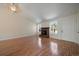 Inviting living room featuring beautiful hardwood floors, a cozy fireplace, and large windows for natural light at 10832 W Powers Pl, Littleton, CO 80127