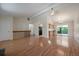Open-concept living space with hardwood floors, kitchen access, and a sliding door to a backyard deck at 10832 W Powers Pl, Littleton, CO 80127