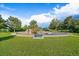 Community playground featuring modern play structures, mature trees and a comfortable bench in a well-maintained green space at 10832 W Powers Pl, Littleton, CO 80127