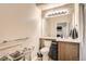 Bathroom with updated floors, large mirror, and neutral color palette; the shower area has modern fixtures at 16320 E Fremont Ave # 1, Aurora, CO 80016