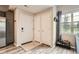 Functional entryway features tile flooring, coat closet, and view into the light-filled living area at 16320 E Fremont Ave # 1, Aurora, CO 80016