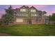 Charming multi-story brick townhome featuring manicured lawn, mature trees, and private balcony at 16320 E Fremont Ave # 1, Aurora, CO 80016