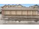 Attached garages with neutral doors in brick building are great for parking and storage at 16320 E Fremont Ave # 1, Aurora, CO 80016