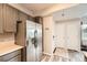 Updated kitchen with stainless steel refrigerator and neutral toned cabinets that are light and airy at 16320 E Fremont Ave # 1, Aurora, CO 80016