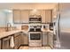 Modern kitchen with stainless steel appliances, light gray cabinetry, and updated countertops at 16320 E Fremont Ave # 1, Aurora, CO 80016