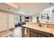 Well-lit kitchen with modern appliances, open to the living room with a fireplace and a neutral color palette at 16320 E Fremont Ave # 1, Aurora, CO 80016