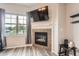 Cozy fireplace and large window provide focal points in this comfortable and bright living room at 16320 E Fremont Ave # 1, Aurora, CO 80016