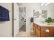 Bathroom with wood-look flooring, a wooden vanity, and an open doorway to the hallway at 205 Wright St # 104, Lakewood, CO 80228