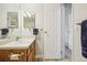 Bathroom with wood-look flooring, a wooden vanity, and an open doorway to the hallway at 205 Wright St # 104, Lakewood, CO 80228