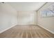 Neutral bedroom offers a calm retreat with large window and plush carpeting at 205 Wright St # 104, Lakewood, CO 80228