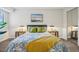 A comfortable bedroom featuring a plush bed with stylish linens and side tables with lamps at 205 Wright St # 104, Lakewood, CO 80228